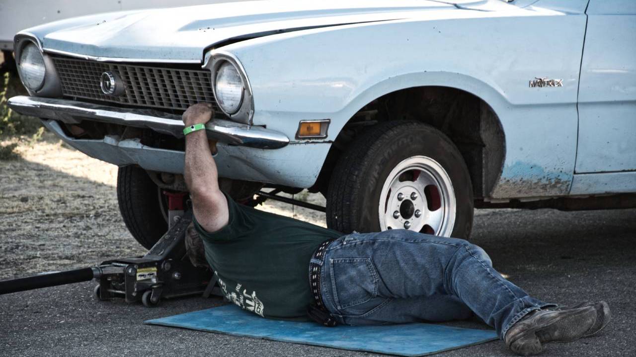 Car being fixed by the roadside