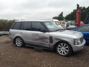 Grey Land Rover with extensive damage