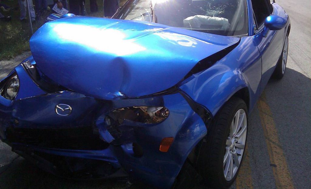 Blue car with crash damage