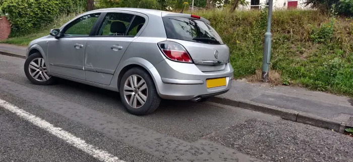 Crash damaged Vauxhall Astra parked at the roadside